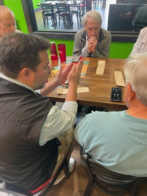Dr. Brent Steele guiding patients through real world hearing aid adjustments in a restaurant
