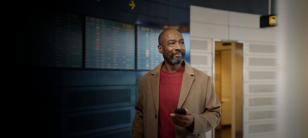 Traveler listening to an Auracast broadcast in an airport